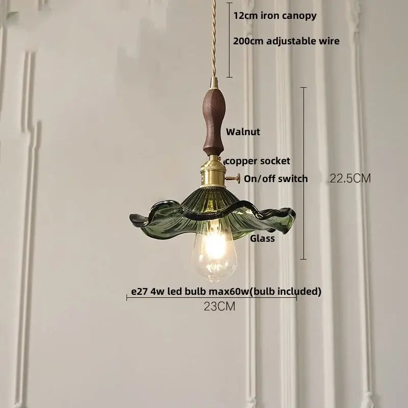 Delicate green glass led pendant lamp with walnut wood handle and brass accents for modern dining room lighting
