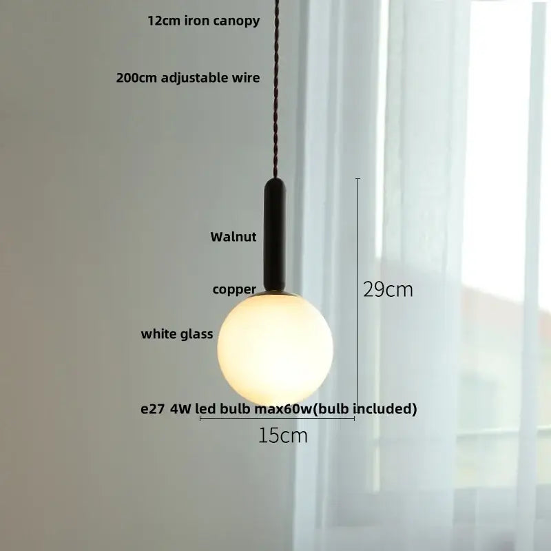 Modern amber glass led pendant light with matte black walnut iron canopy copper accent and frosted glass globe