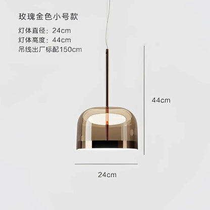A modern amber glass pendant light with minimalist design and copper finish perfect for dining room use
