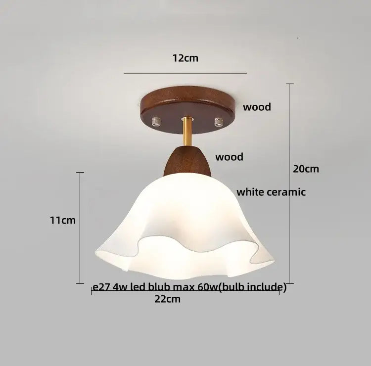 A white ceramic fluted lampshade with brass stem atop wood fixture in decorbites amber glass wood ceiling light