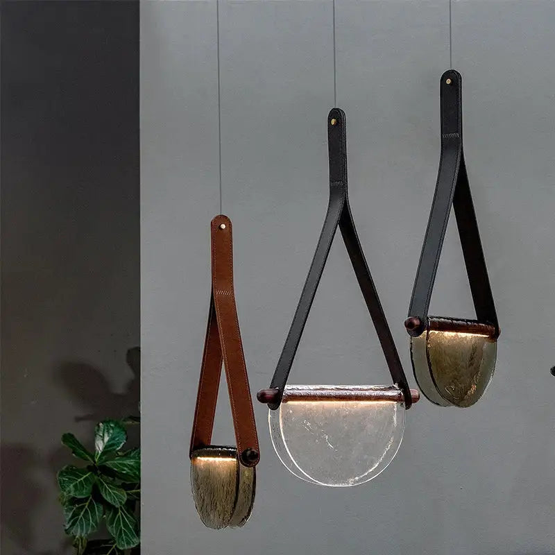 Three modern pendant lamps with decorbites handmade leather straps and amber gray glass bowls for bedroom decor