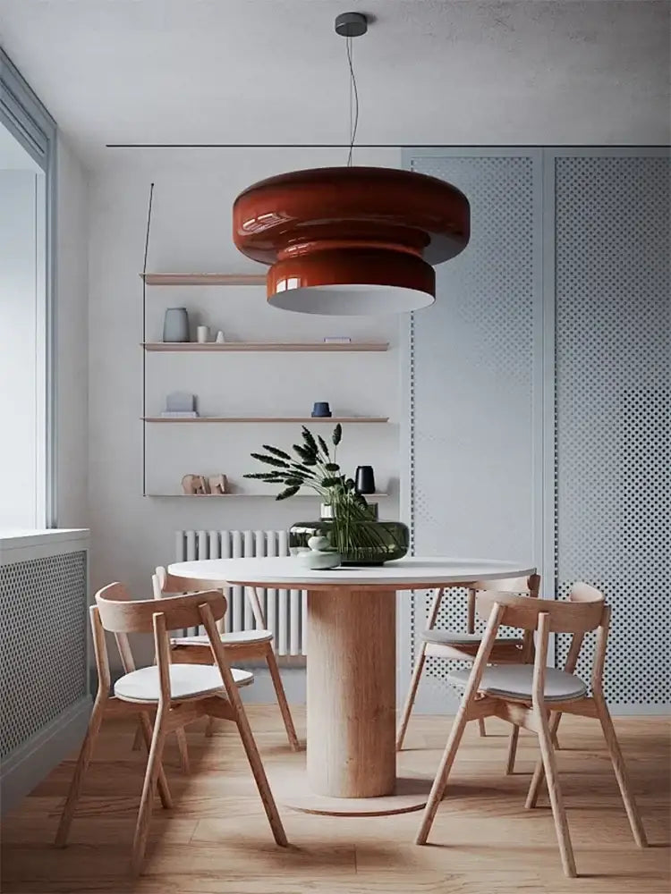 A sleek layered red pendant light with glossy finish hangs above dining table modern amber green glass decorbites pendant light