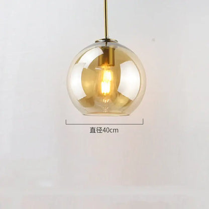 Modern amber glass ball led pendant light with brass fixture and exposed filament bulb for dining room decorbites glass ball