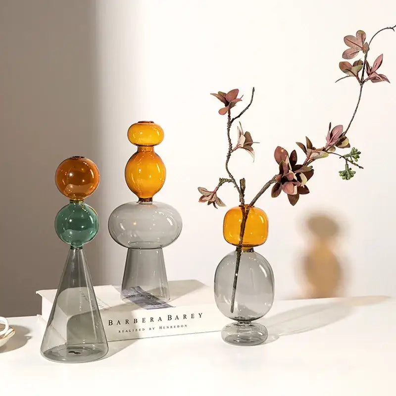 Three modern amber and teal glass vases with double glazing stained spherical tops for living room decor