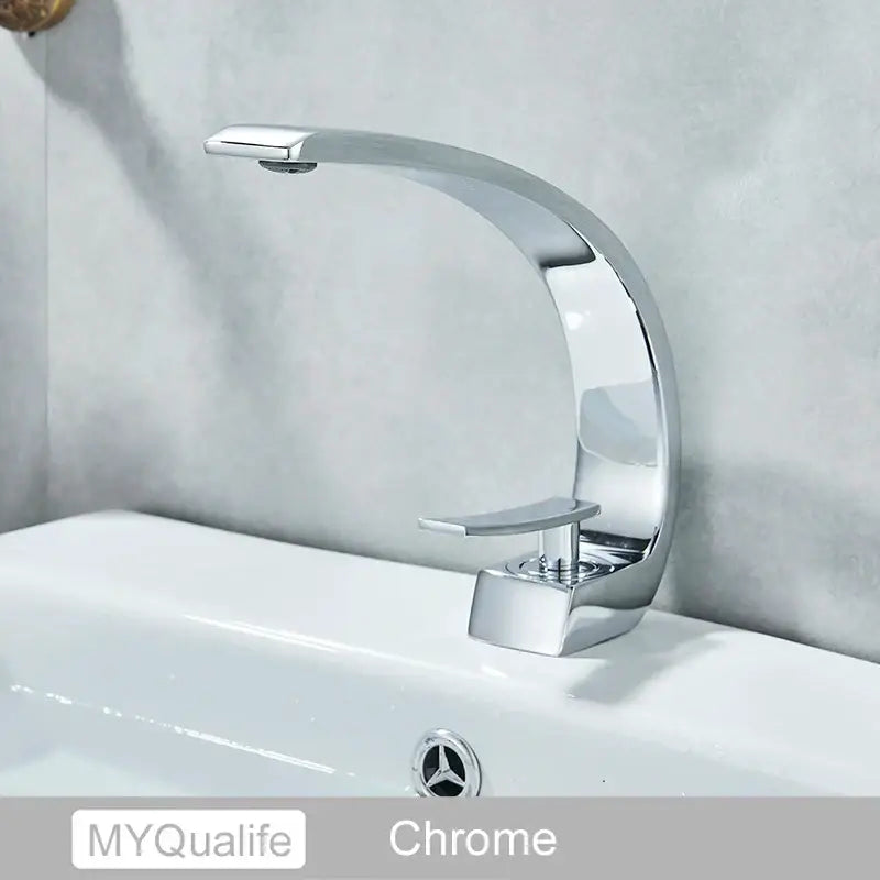 Modern arched brushed gold basin faucet with a chrome-finished sleek curved spout and rectangular handle for bathroom use