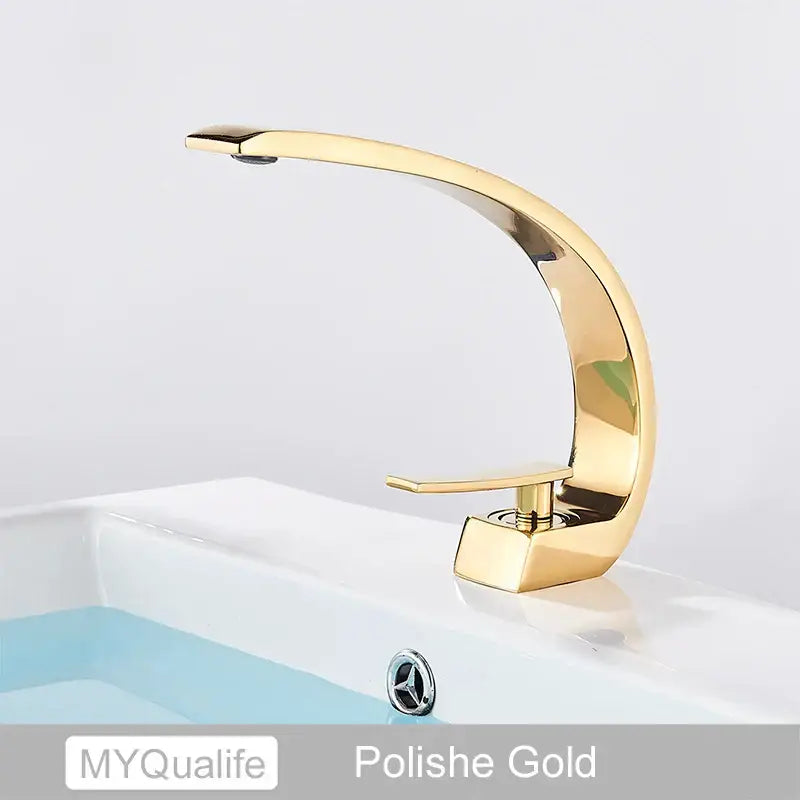 Polished gold single-handle modern arched brushed gold basin faucet with sleek curved design for bathroom use