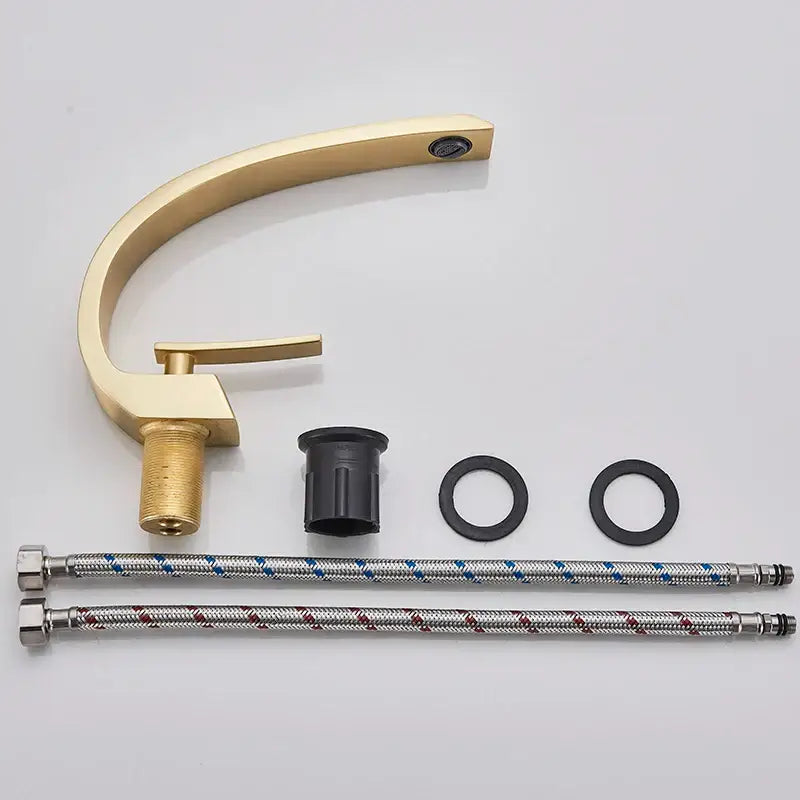 Modern arched brushed gold basin faucet with sleek curved spout single handle and flexible braided hoses in silver