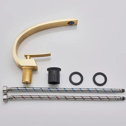Modern arched brushed gold basin faucet with sleek curved spout single handle and flexible braided hoses in silver