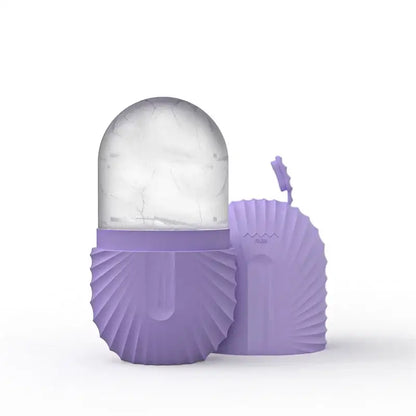 Purple silicone clamshell-shaped ice cube tray with clear marble-patterned dome for modern arched pink marble facial roller massager