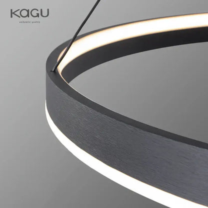 Modern artistic black chandelier featuring a circular pendant light with brushed metal finish and warm led ring lighting by decorbites artistic black