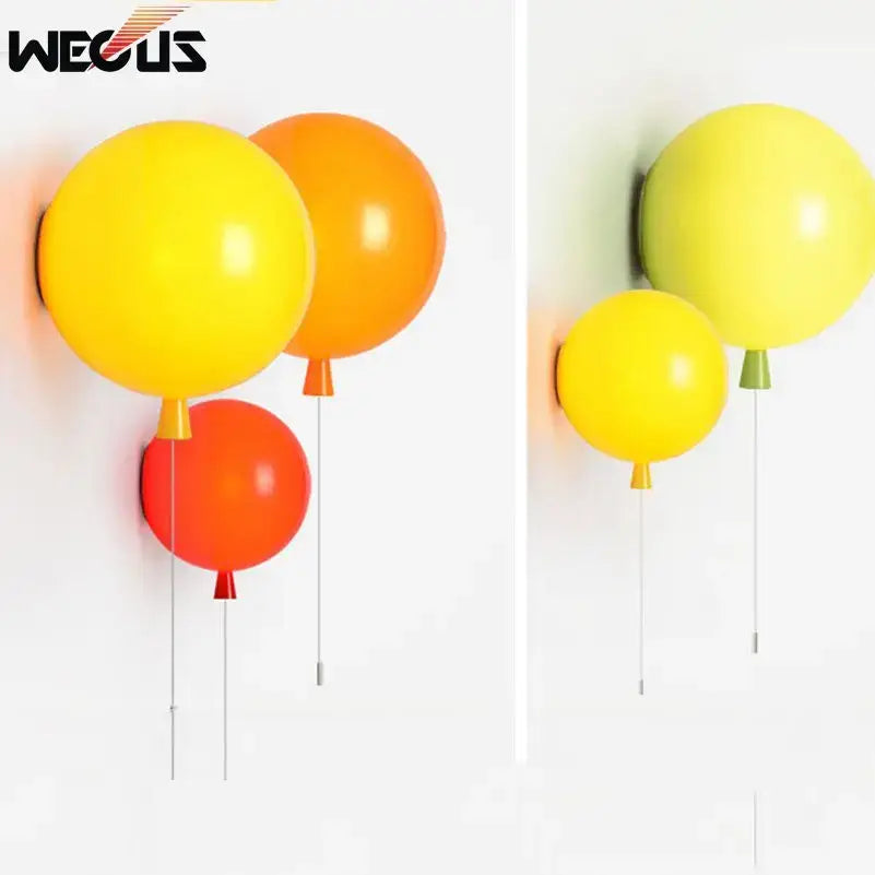 Modern balloon wall light with vibrant glossy yellow orange and red balloon-shaped lamps and matching colored stems
