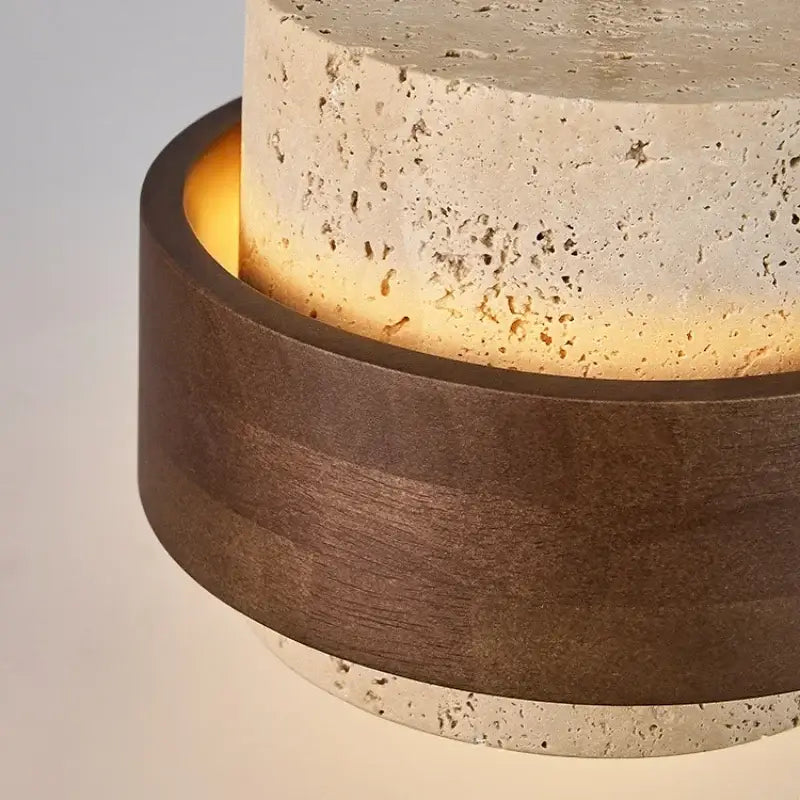 Modern table lamp with textured beige stone upper and warm light from dark walnut wood finish base for dining room