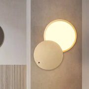 Modern beige and gold metal wall lamp with rotatable led and overlapping disc shades for bedroom sconce lighting