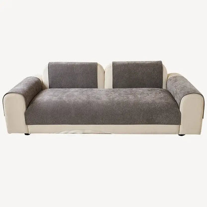 Modern two-seater sofa with gray textured fabric and white leather-like armrests, featuring a beige and gray chenille cover