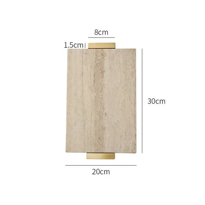 Modern beige travertine stone tray with gold handle decor and wall-mounted light fixture featuring textured stone face