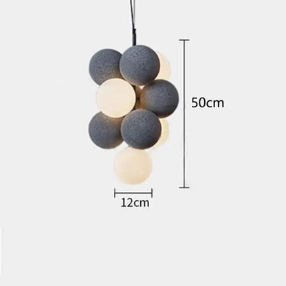 A modern beige and white abstracta pendant lamp with matte gray and cream spherical bulbs for dining room decor
