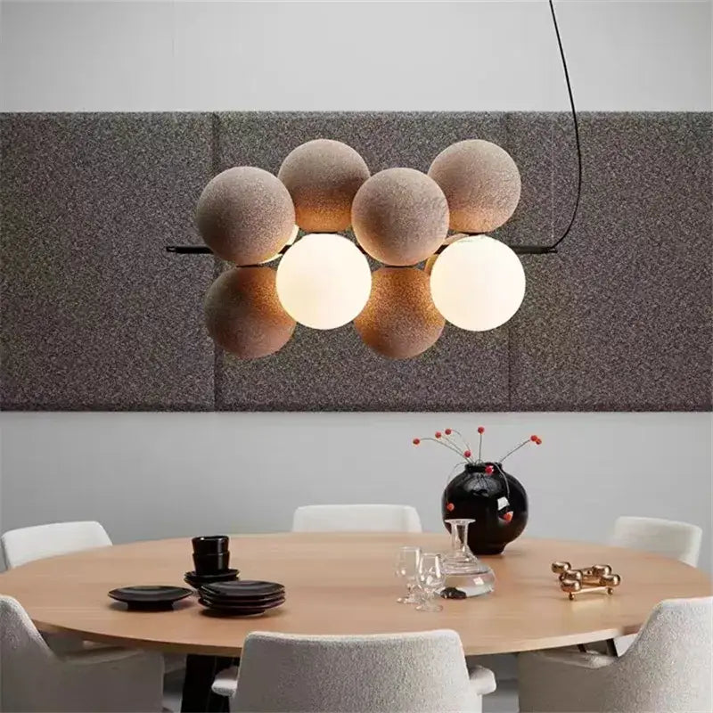 Modern beige and white abstracta pendant lamp featuring matte glass orbs suspended by black metal arms for dining room decorbites pendant lamp