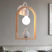 Modern beige wooden arched wall lamp with white ceramic bulb and bird decor powered by a nine inches power source