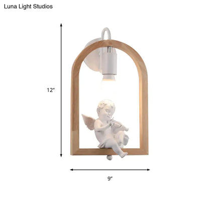 Modern beige wooden arched wall lamp with white ceramic cherub decor and power source, measuring nine inches tall