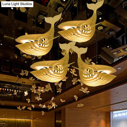 Modern beige wooden whale kids pendant light with layered design and warm internal illumination for bedroom use
