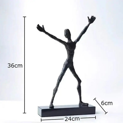 Black abstract lovers sculpture with outstretched arms and legs on rectangular base as modern desk ornament