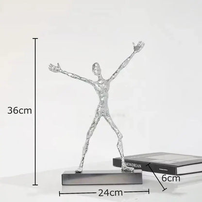 Silver metallic abstract lovers sculpture with arms outstretched on base as modern lovers sculpture desk ornament