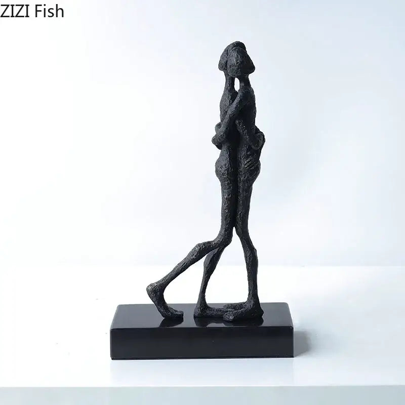 Modern black matte abstract lovers sculpture desk ornament featuring two figures in an embrace on a rectangular base