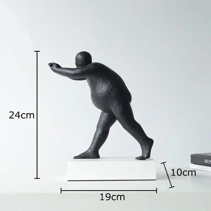 Modern black abstract resin sculpture of a stylized overweight person in mid-stride for home decor on white base