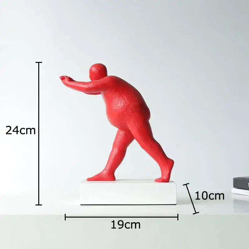 Vibrant red muscular man figurine on white base modern black abstract resin sculpture for home decor