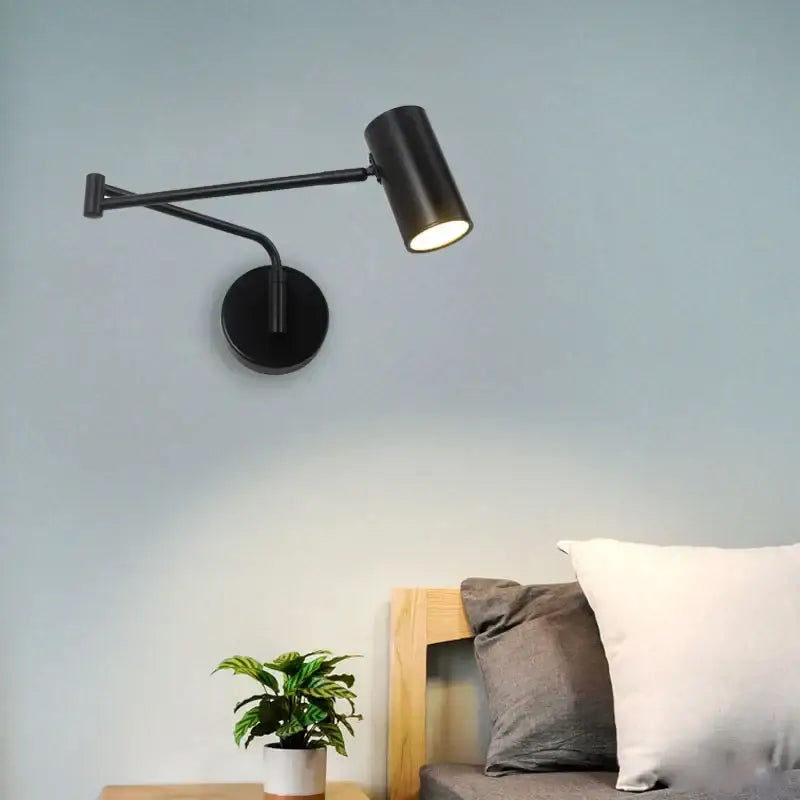 Modern black acrylic iron led wall lamp with matte finish, adjustable arm, and cylindrical head for bedroom reading