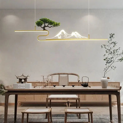 Gold-toned minimalist pendant lights with illuminated acrylic mountain peak and bonsai tree decorbites acrylic mountain design