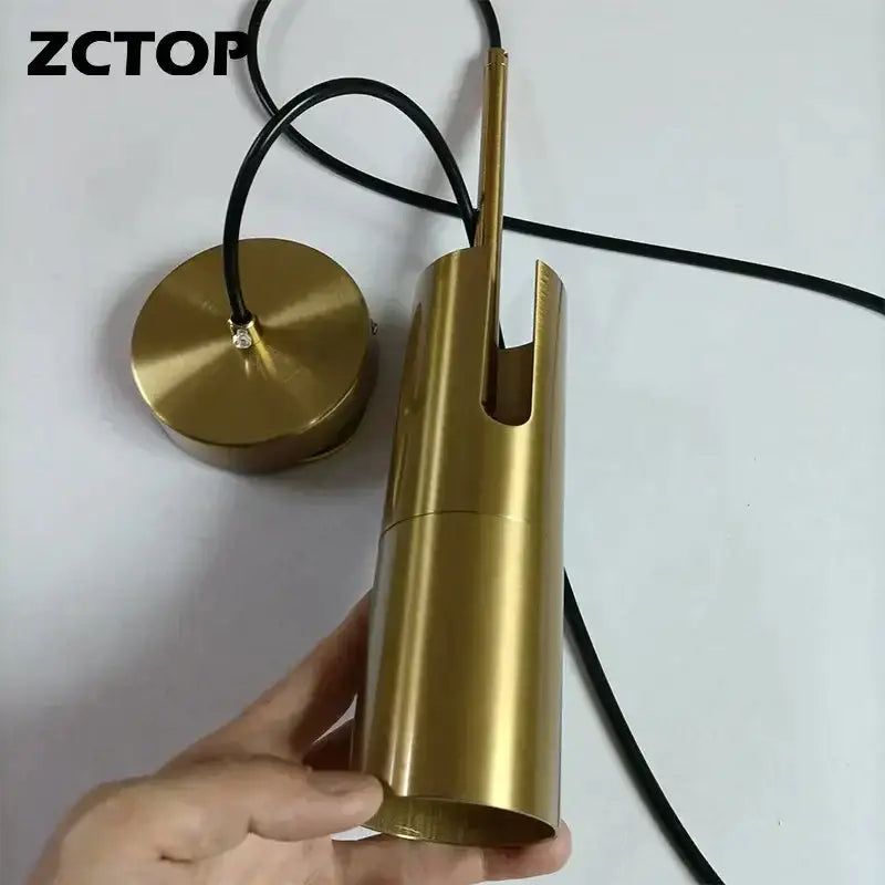 Gold-finished cylindrical pendant light with black cord for modern black adjustable led spotlight chandelier decorbites