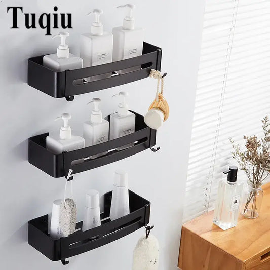 Black aluminum wall-mounted corner shelf with three tiers and hooks holding white pump bottles for bathroom storage