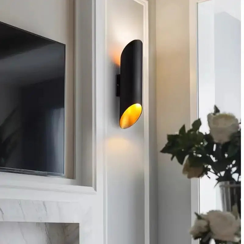 Modern black aluminum tube wall lamp featuring a cylindrical design with warm amber light for bedroom decorbites black aluminum sconce