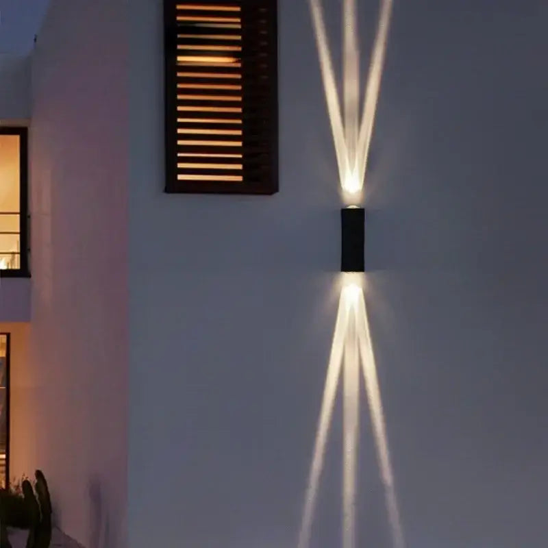 Modern black aluminum waterproof porch wall lamp casting three warm white beams as a waterproof porch spot light