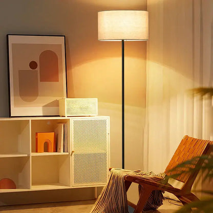 Modern black and beige led vertical floor lamp with cylindrical fabric shade and sleek metal pole for living room use