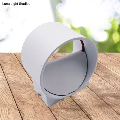 White cylindrical wall light with sleek modern design and matte finish in a modern black and blue velvet wall light kit