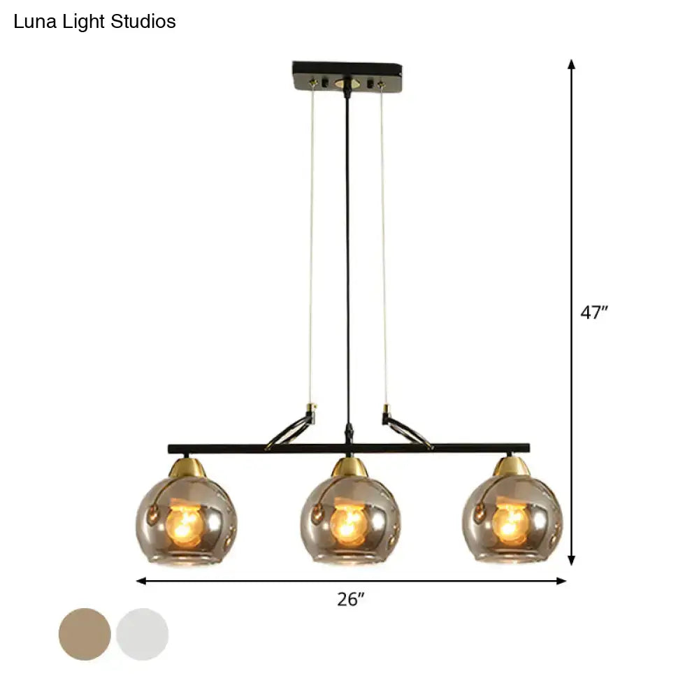 DecorBites contemporary black metal 3-bulb pendant light with smoke gray glass and brass accents for hall island