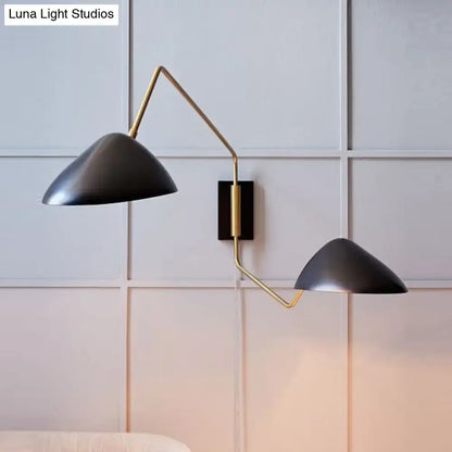 Modern black and brass metal duckbill reading wall sconce with matte black conical shades and articulated arms for bedroom use