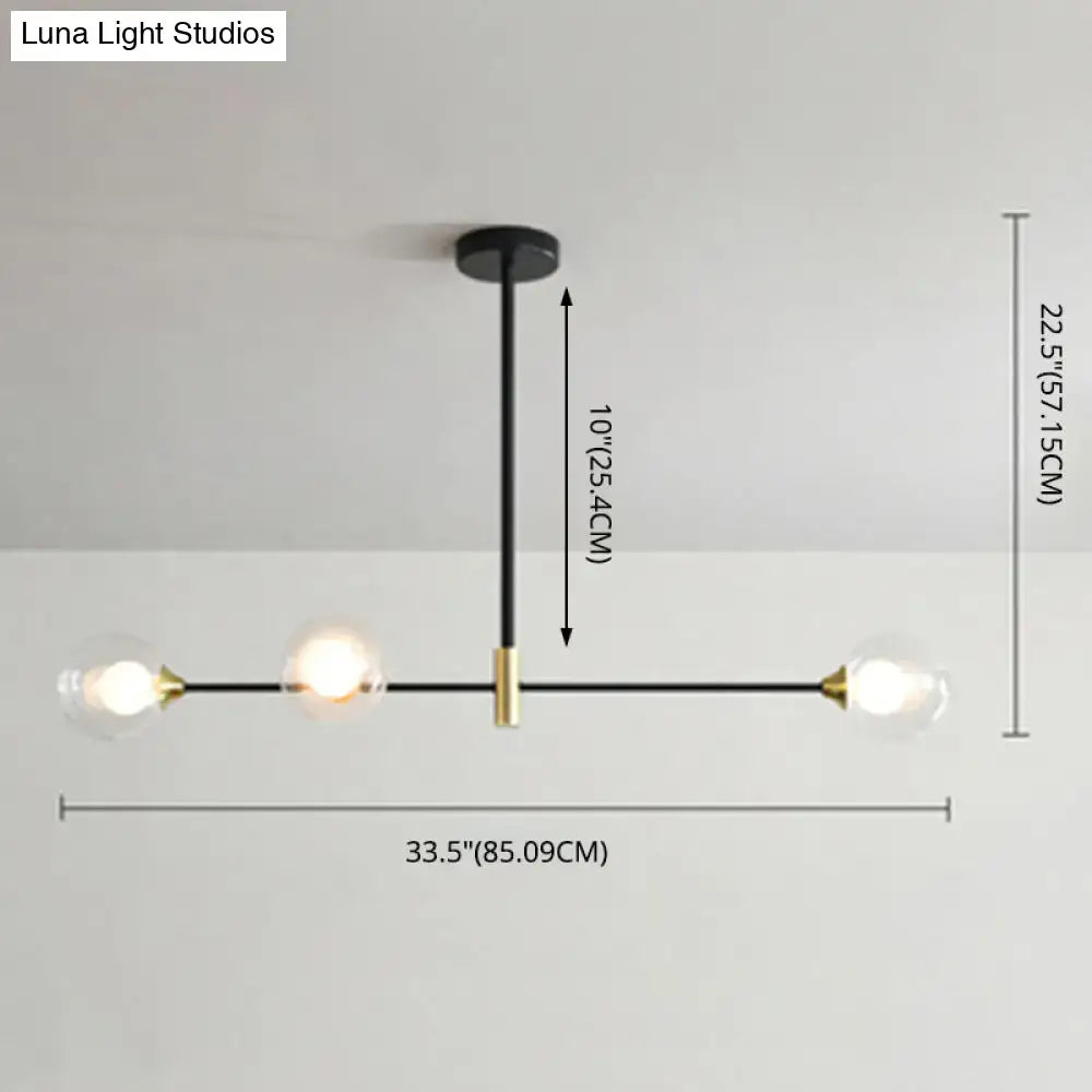 Modern black and brass metal island pendant chandelier with three clear glass globe bulbs and adjustable chain cord length
