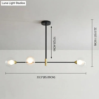 Modern black and brass metal island pendant chandelier with three clear glass globe bulbs and adjustable chain cord length