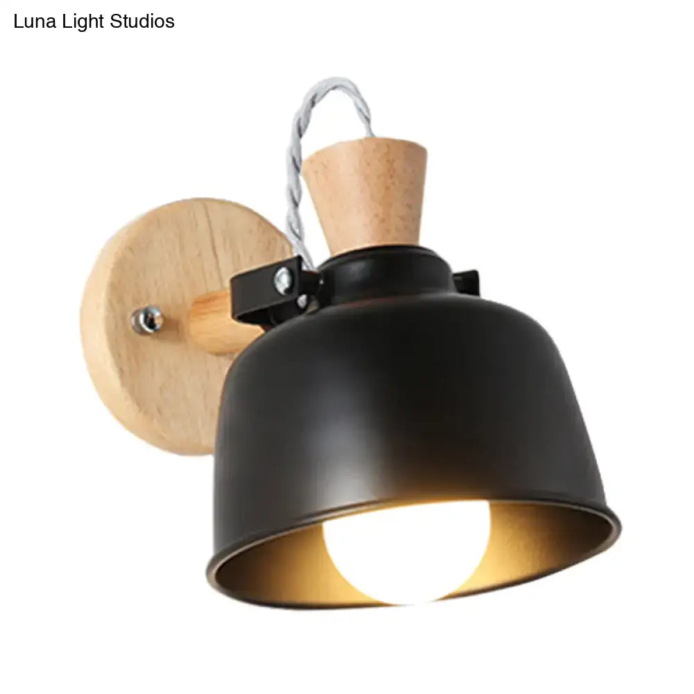 Modern black and brass metal wall light with matte black metal pendant and wooden mounting plate for bedroom use