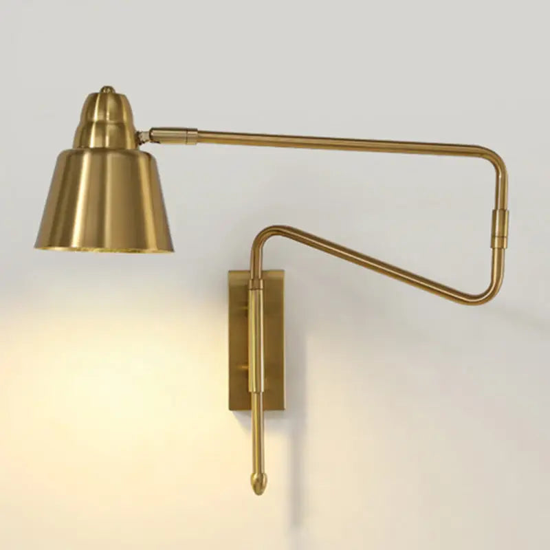Modern black and brass bedroom reading lamp with brass-finished retractable arm and sleek conical shade wall sconce