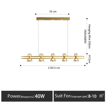 Modern black and chrome linear led strip lamp with gold-toned pendant light and faceted glass shades for kitchen island lighting