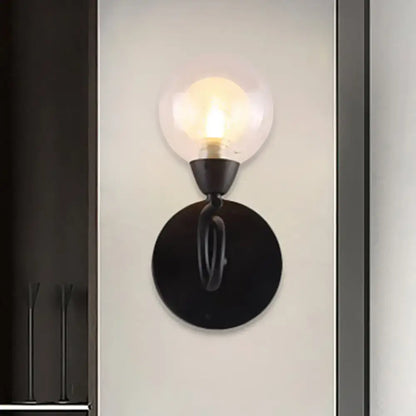 Modern black wrought iron wall lamp with clear glass globe light fixture for living room illumination