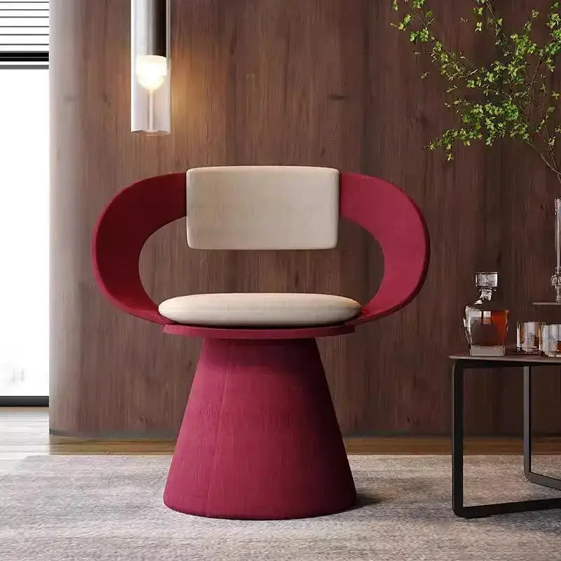 A modern red and cream elegant rotating chair with sculptural frame and cushioned seat for bedroom makeup use
