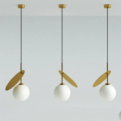 Three modern pendant lights with white glass cherry shades, black cords, and gold accents for dining room decorbites glass cherry