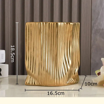 Modern black and gold decorbites ceramic bag vase with golden vertical ribbed texture for living room decor