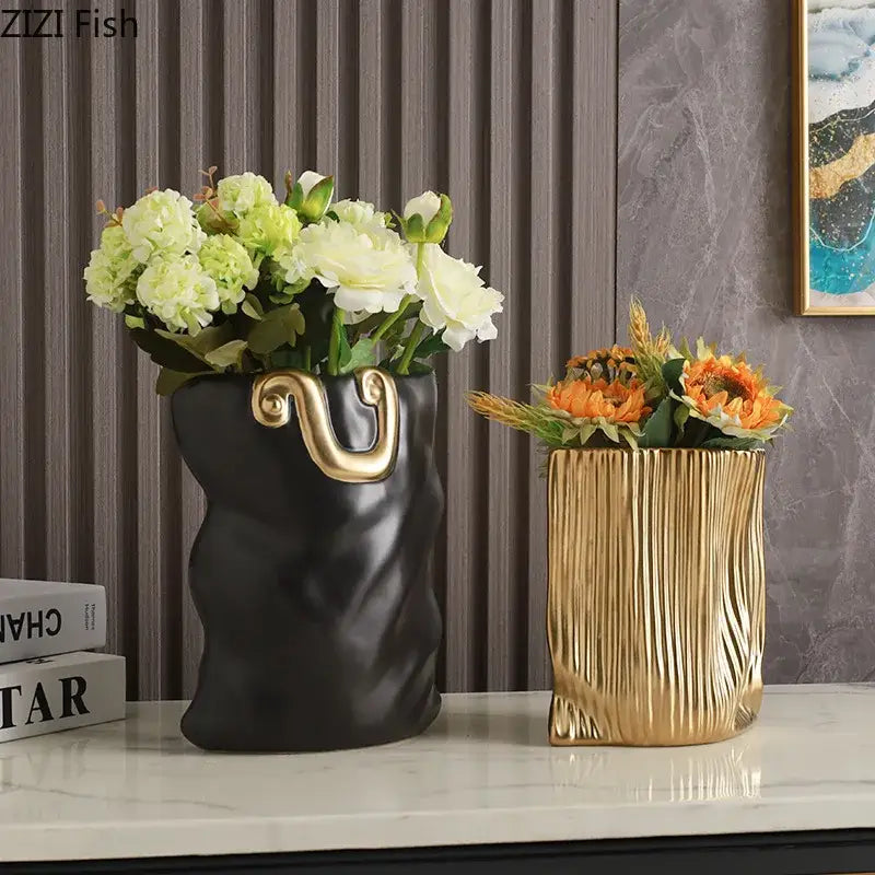 Modern black and gold decorbites ceramic bag vase with textured surface holding white and green flowers for living room decor