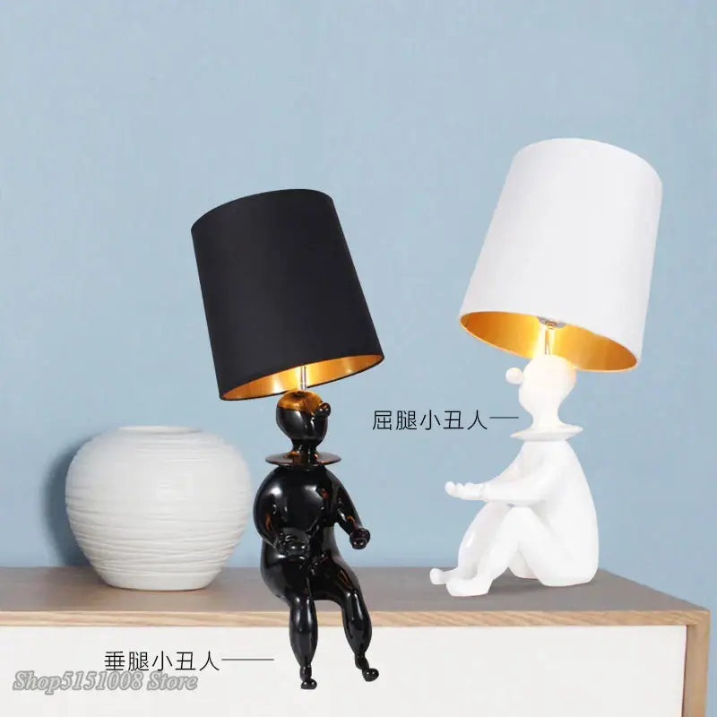 Modern black and gold ceramic decorbites clown desk lamp with glossy figurine base and matte black shade with gold interior